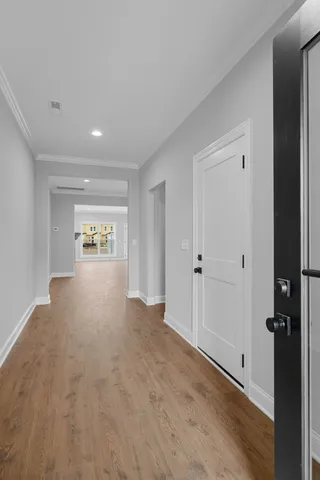 a view of a hallway with wooden floor