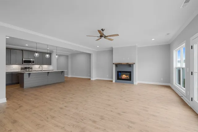 a view of a kitchen with a sink and a fireplace