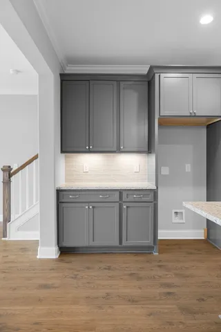 a kitchen with granite countertop a refrigerator and a sink