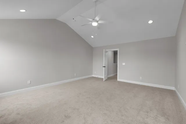 an empty room with a ceiling fan and a window