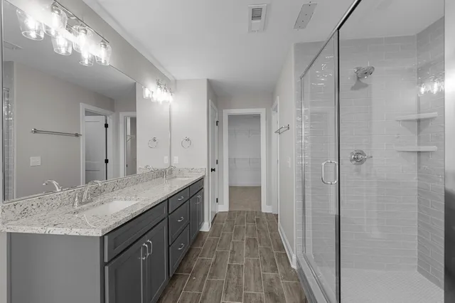 a bathroom with a glass shower door