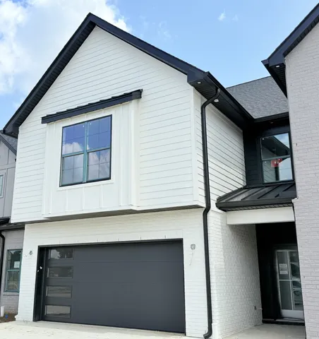 a front view of a house with garage