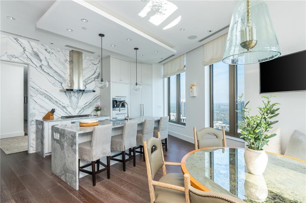 3376 Peachtree Road Northeast, Unit PH51 Atlanta, GA 30326 - Photo 18 of 43 a view of a dining room with furniture window and wooden floor