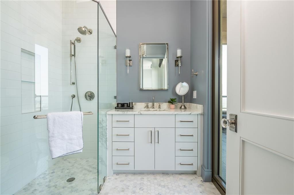 3376 Peachtree Road Northeast, Unit PH51 Atlanta, GA 30326 - Photo 24 of 43 a bathroom with a double vanity sink mirror and shower