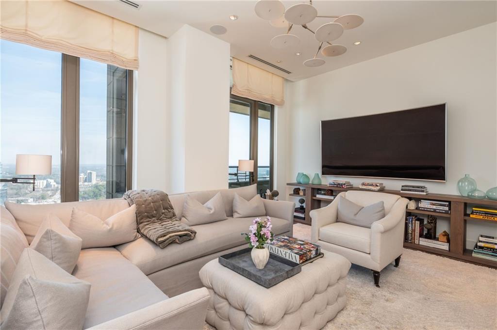 3376 Peachtree Road Northeast, Unit PH51 Atlanta, GA 30326 - Photo 25 of 43 a living room with furniture and a flat screen tv