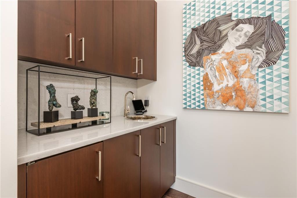 3376 Peachtree Road Northeast, Unit PH51 Atlanta, GA 30326 - Photo 28 of 43 a kitchen with a sink a microwave and cabinets