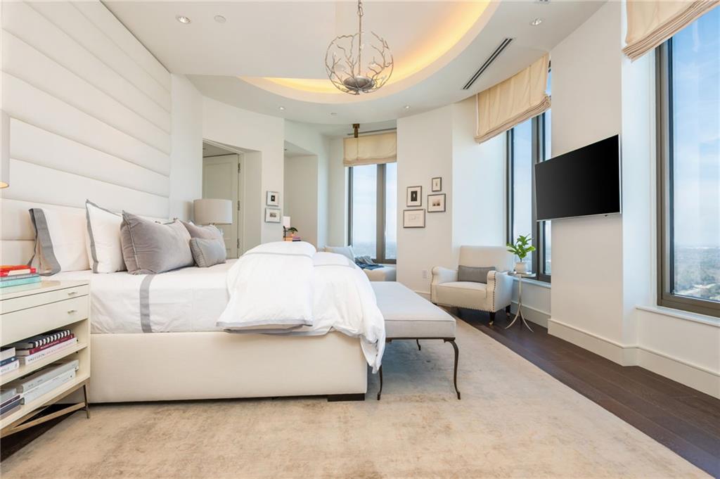 3376 Peachtree Road Northeast, Unit PH51 Atlanta, GA 30326 - Photo 29 of 43 a bedroom with a bed and a flat screen tv