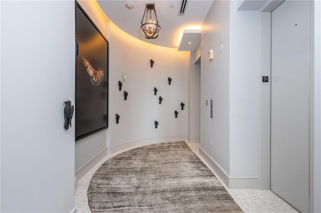 3376 Peachtree Road Northeast, Unit PH51 Atlanta, GA 30326 - Photo 3 of 43 a view of a hallway with wooden walls and entryway