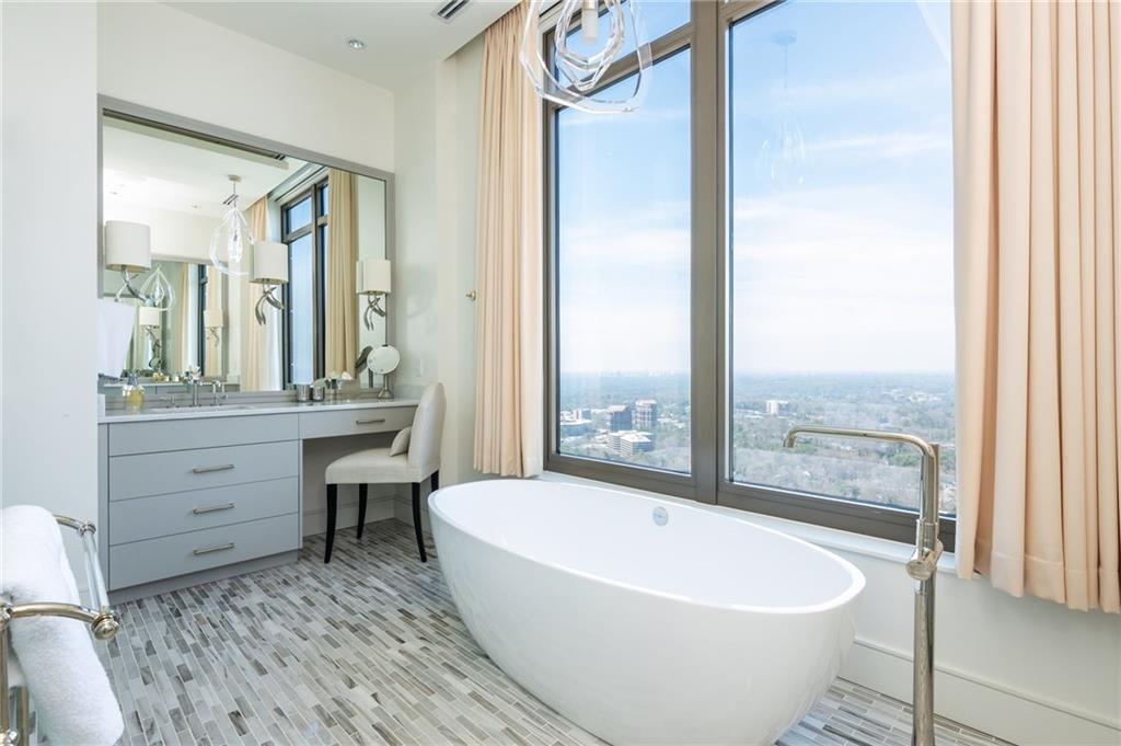 3376 Peachtree Road Northeast, Unit PH51 Atlanta, GA 30326 - Photo 32 of 43 a bathroom with a bathtub and a sink