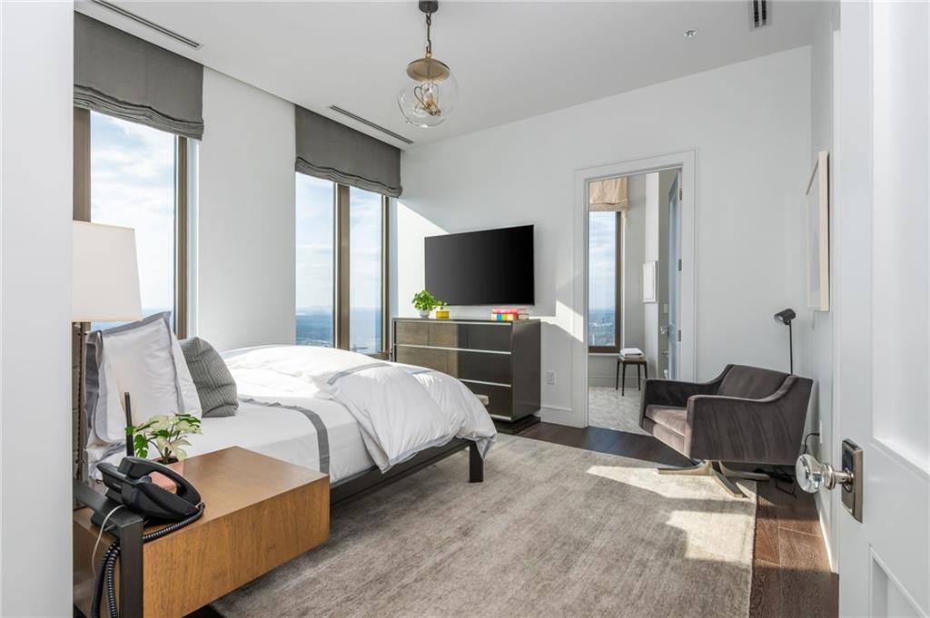 3376 Peachtree Road Northeast, Unit PH51 Atlanta, GA 30326 - Photo 34 of 43 a spacious bedroom with a bed and a flat screen tv