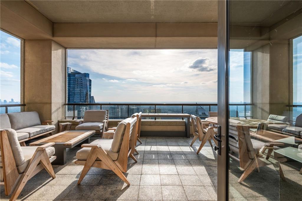 3376 Peachtree Road Northeast, Unit PH51 Atlanta, GA 30326 - Photo 37 of 43 a bedroom with furniture and large windows