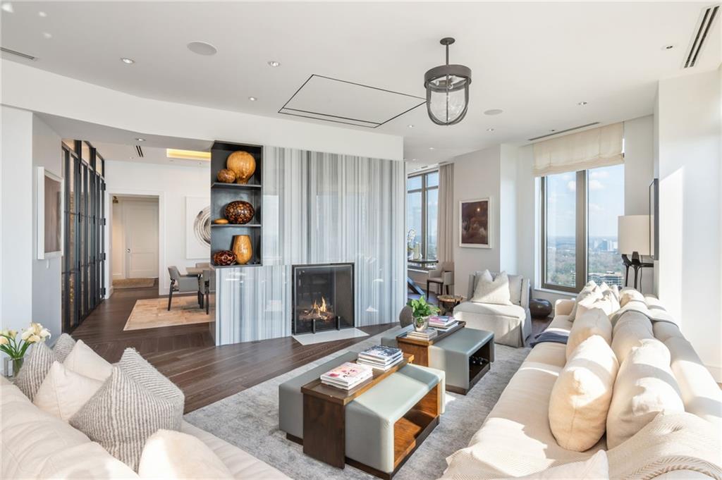 3376 Peachtree Road Northeast, Unit PH51 Atlanta, GA 30326 - Photo 7 of 43 a living room with furniture a fireplace and a table