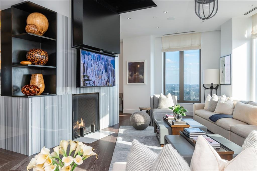 3376 Peachtree Road Northeast, Unit PH51 Atlanta, GA 30326 - Photo 8 of 43 a living room with furniture and a fireplace