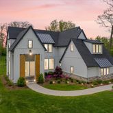 a front view of a house with a yard table and chairs