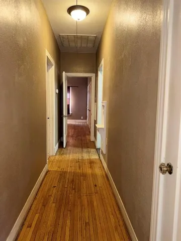 a view of a room with wooden floor and staircase