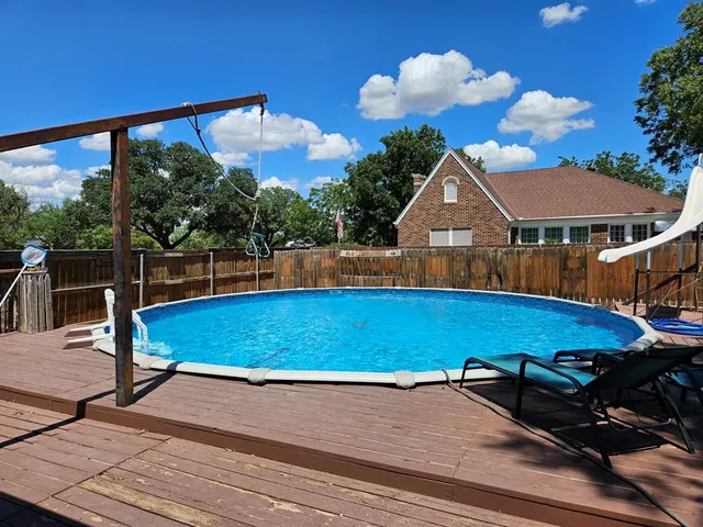 a view of a patio with a table and chairs