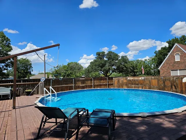 a view of a swimming pool with a patio
