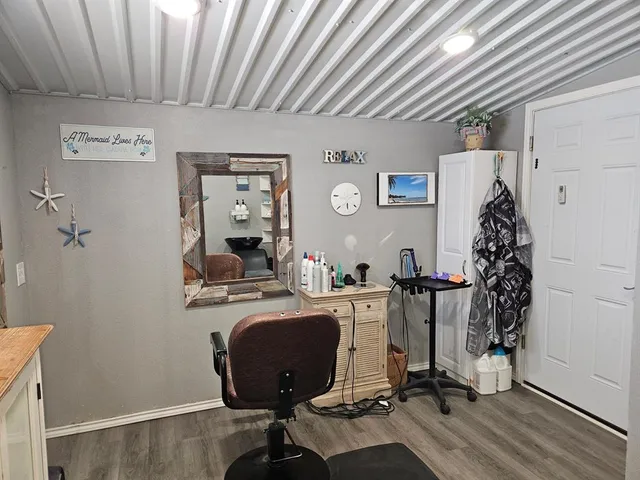 a view of a patio with table and chairs barbeque with wooden floor and fence