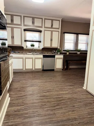 a kitchen with stainless steel appliances kitchen island granite countertop a stove a sink and a microwave