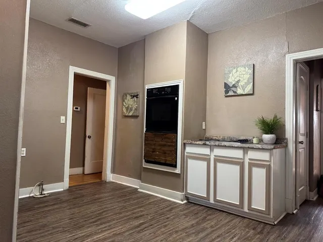 a kitchen with stainless steel appliances granite countertop a stove and a refrigerator