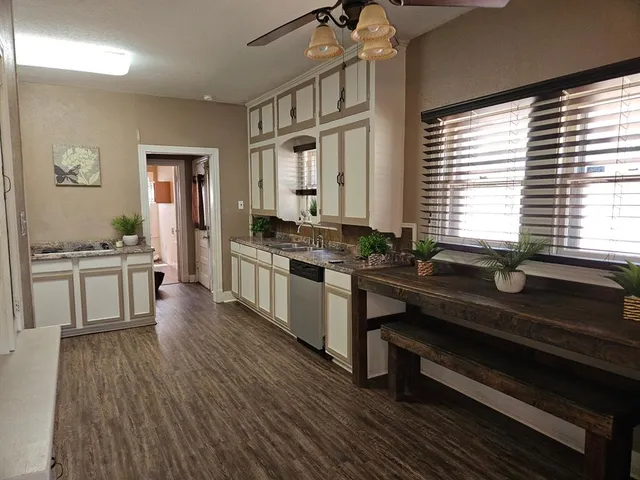 a kitchen with granite countertop lots of counter top space and stainless steel appliances