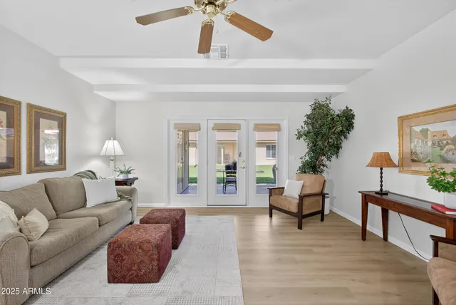 a living room with furniture a lamp a rug and a window
