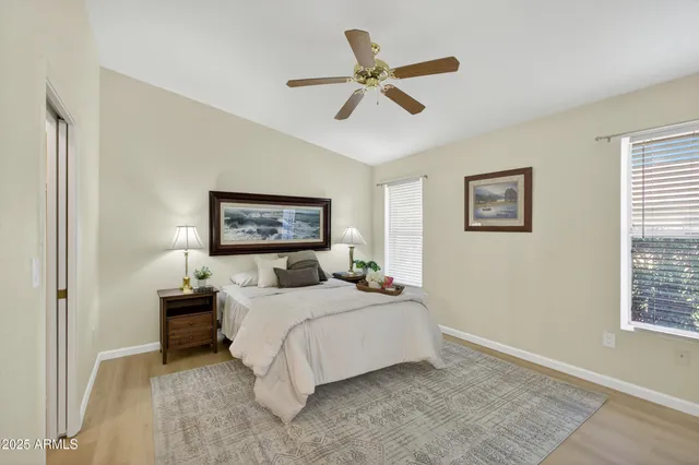 a bedroom with bed and a chandelier