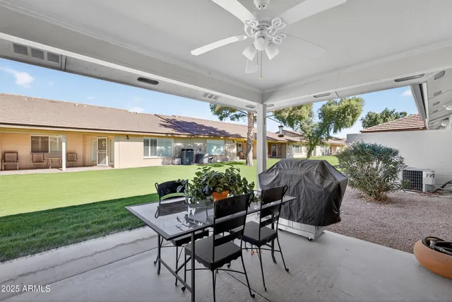 a view of a house with a backyard and a patio