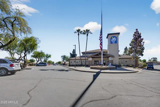 a view of a patio with a table and chairs under an umbrella