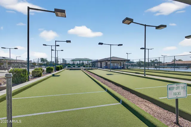 a view of a house with furniture and a yard