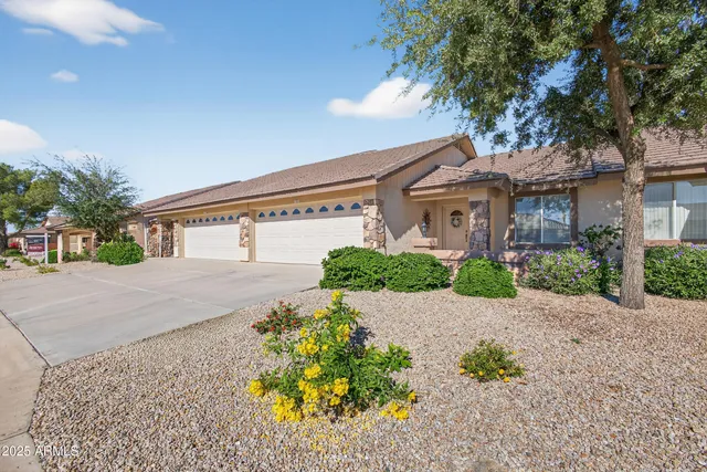 a front view of a house with a yard and a garage