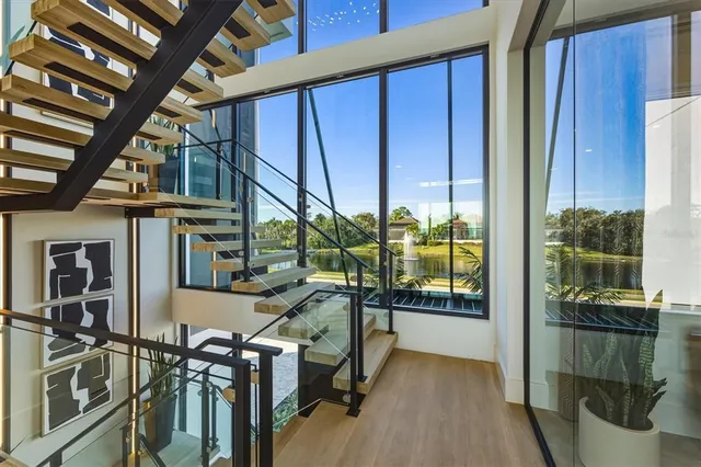 a living room with furniture potted plant and a large window