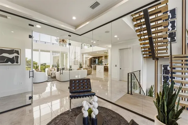 a living room with furniture a flat screen tv and a floor to ceiling window