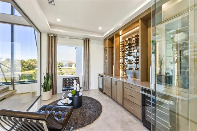 a view of a balcony with chairs and wooden floor