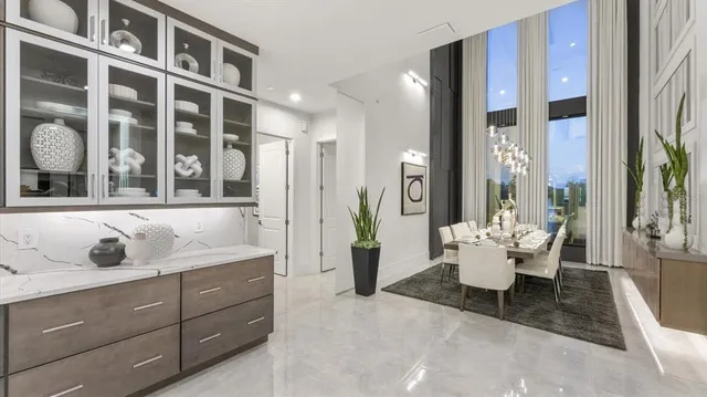 a living room with furniture potted plant and a large window