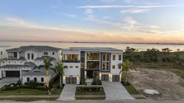 a living room with furniture a chandelier and a large mirror