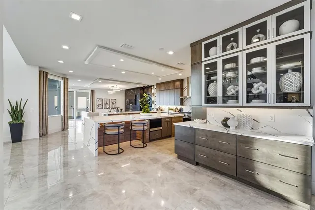 a spacious bedroom with a bed and dresser