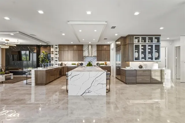 a bathroom with a granite countertop sink a toilet and mirror
