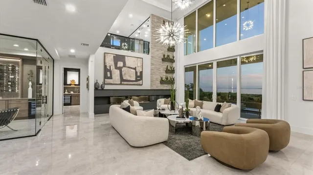 a view of staircase with lots of frames on wall and a window