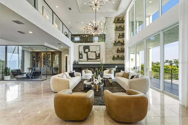 a living room with furniture and large windows