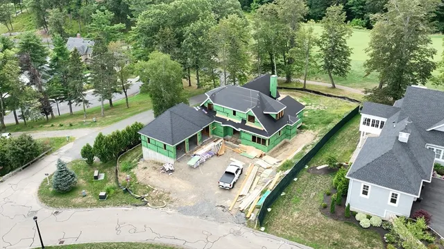 an aerial view of a house with garden space and street view