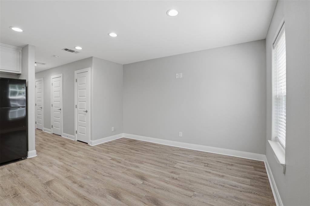 1022 West Shepherd Street, Unit 1022 Denison, TX 75020 - Photo 5 of 27 a view of an empty room with wooden floor
