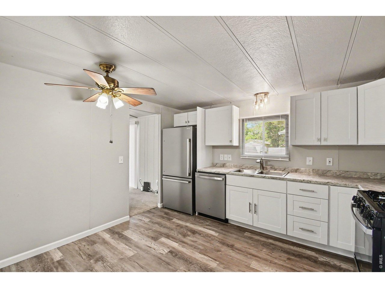 8317 6th Street Wellington, CO 80549 - Photo 8 of 21 Updated kitchen featuring new appliances, eat-in space and modern finishes