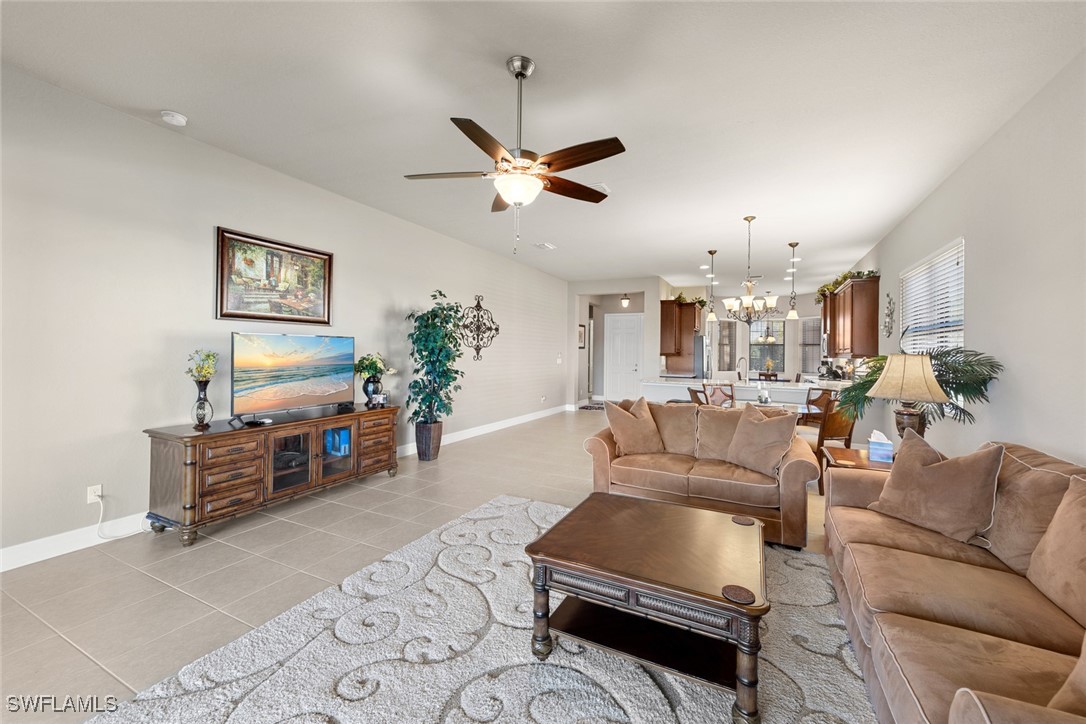 11652 Meadowrun Circle Fort Myers, FL 33913 - Photo 13 of 38 a living room with furniture and a chandelier