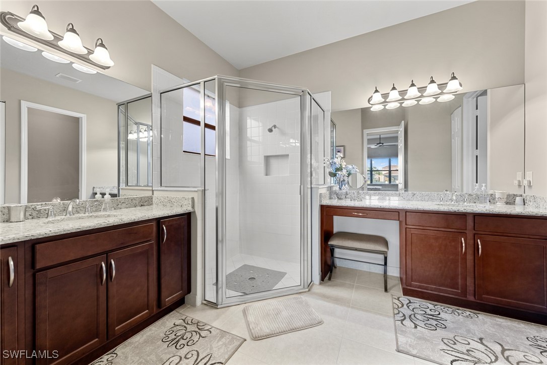 11652 Meadowrun Circle Fort Myers, FL 33913 - Photo 18 of 38 a bathroom with a double vanity sink and a mirror