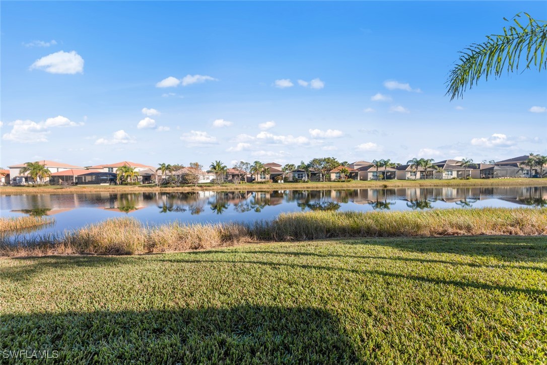 11652 Meadowrun Circle Fort Myers, FL 33913 - Photo 27 of 38 a view of a lake with houses in the back