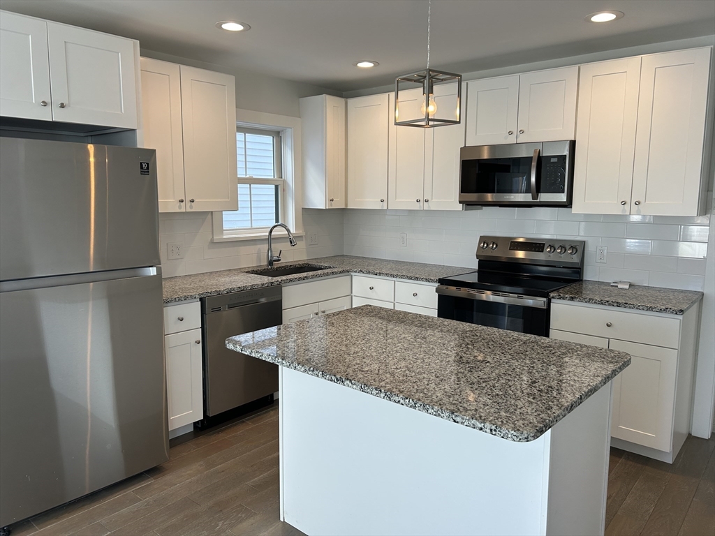 17 North End Boulevard, Unit A Salisbury, MA 01952 - Photo 1 of 13 a kitchen with stainless steel appliances granite countertop a sink stove and refrigerator