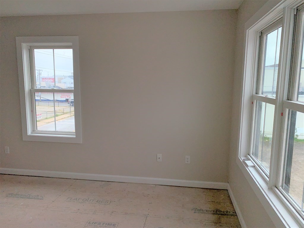 17 North End Boulevard, Unit A Salisbury, MA 01952 - Photo 11 of 13 an empty room with windows