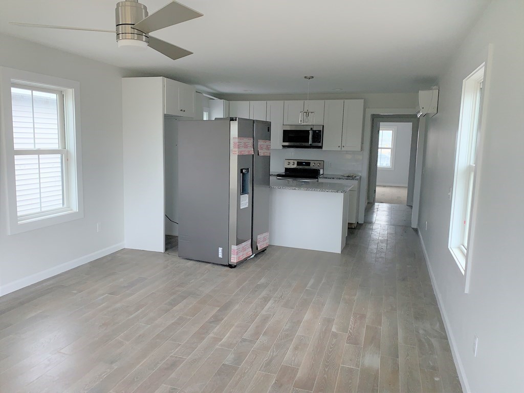 17 North End Boulevard, Unit A Salisbury, MA 01952 - Photo 3 of 13 a view of a kitchen with stainless steel appliances a refrigerator and a stove top oven