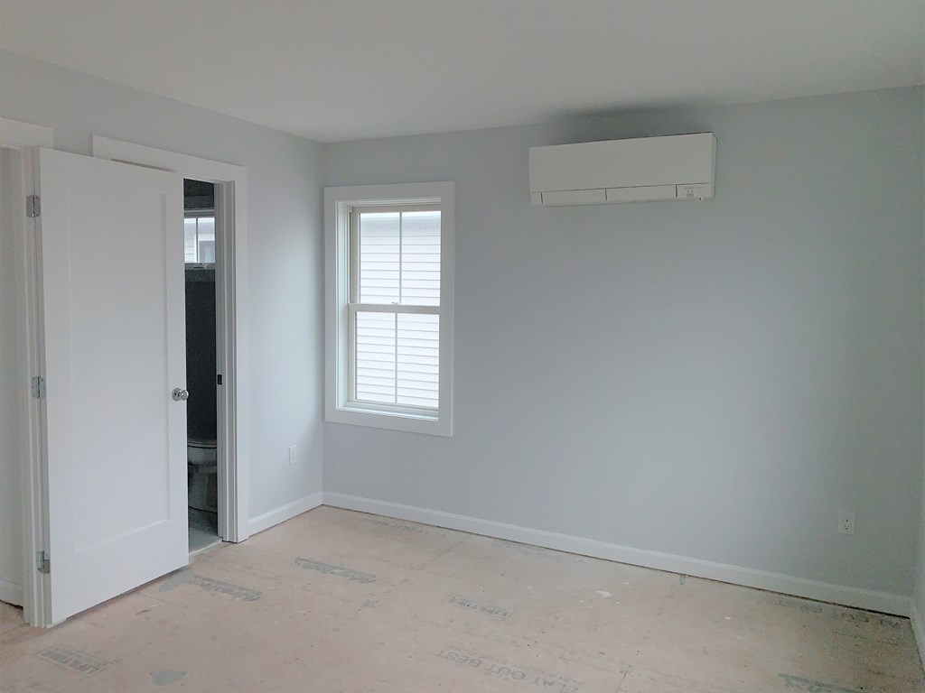 17 North End Boulevard, Unit A Salisbury, MA 01952 - Photo 6 of 13 an empty room with windows